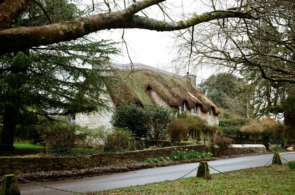A traditional cottage tucked behind a stone garden wall